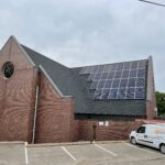 Sloped roof solar panels at Ezekiel Lutheran Church, River Falls, Wisconsin with the Energy Concepts install van